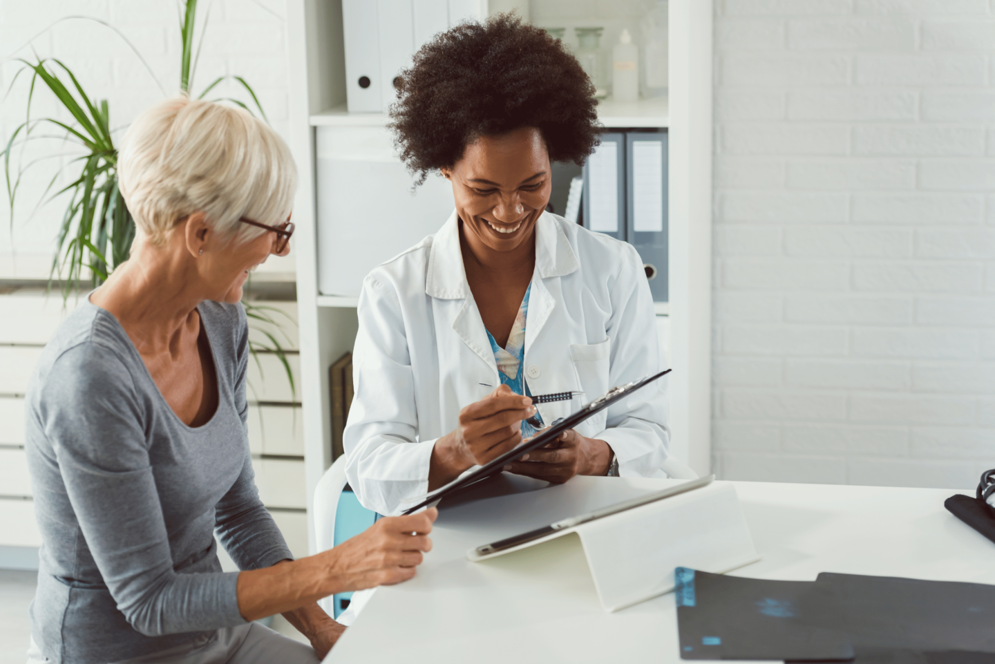 https://www.baywater.co.uk/app/uploads/2022/08/A-female-doctor-sits-at-her-desk-and-chats-to-an-elderly-female-patient-while-looking-at-her-test-results-1440x961.png