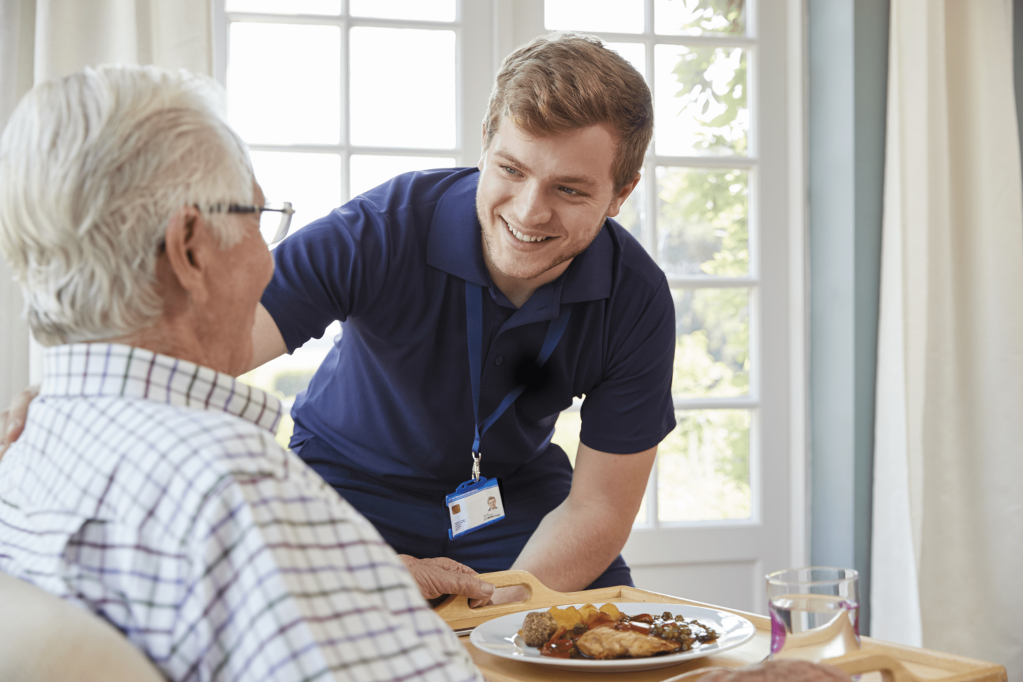 https://www.baywater.co.uk/app/uploads/2022/08/Male-care-worker-serving-dinner-to-a-senior-man-at-his-home-1440x960.png