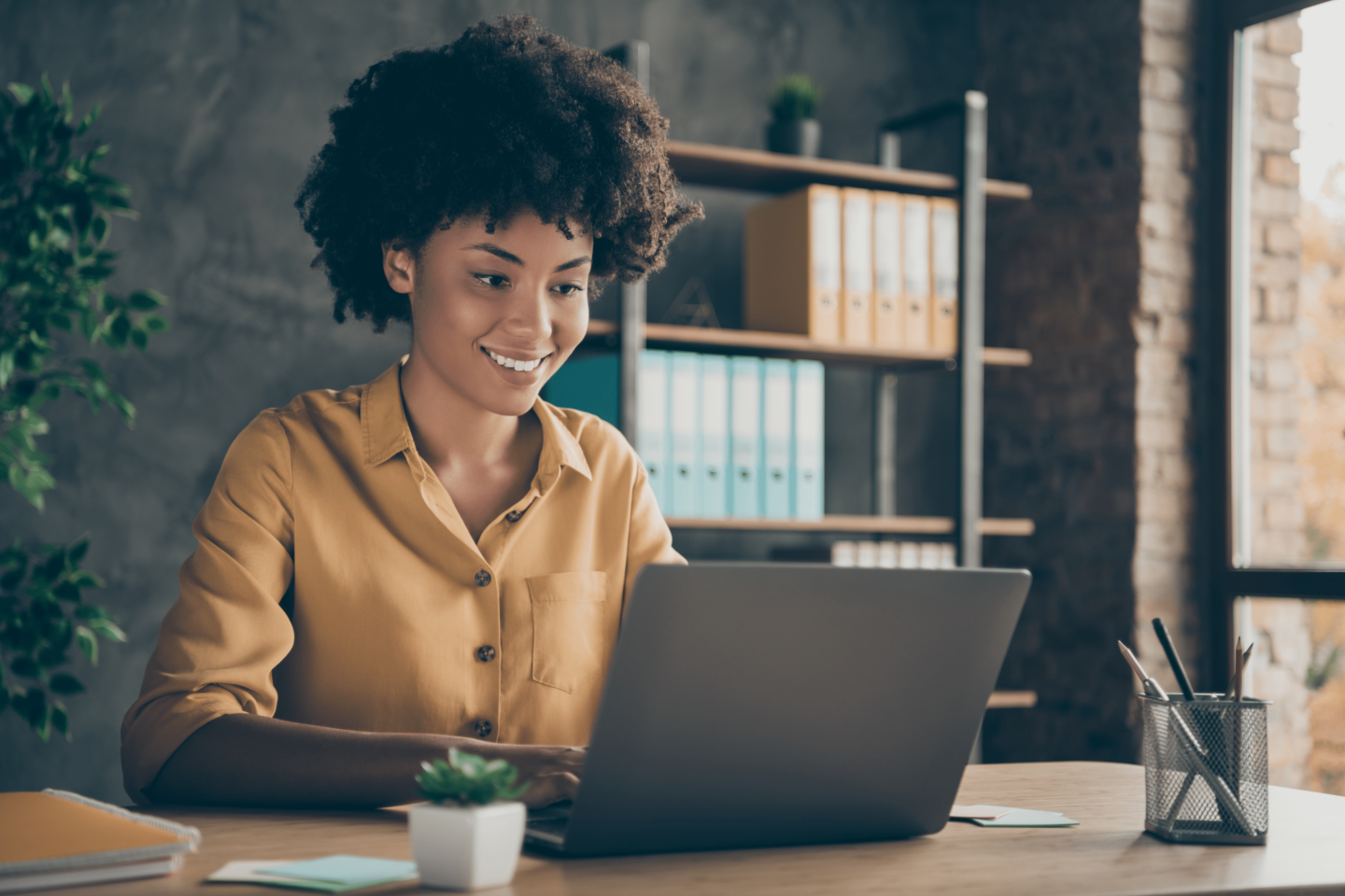 https://www.baywater.co.uk/app/uploads/2022/08/Photo-of-cheerful-positive-mixed-race-girl-smiling-toothily-working-on-presentation-about-her-corporation-using-laptop-on-desktop-1440x960.png